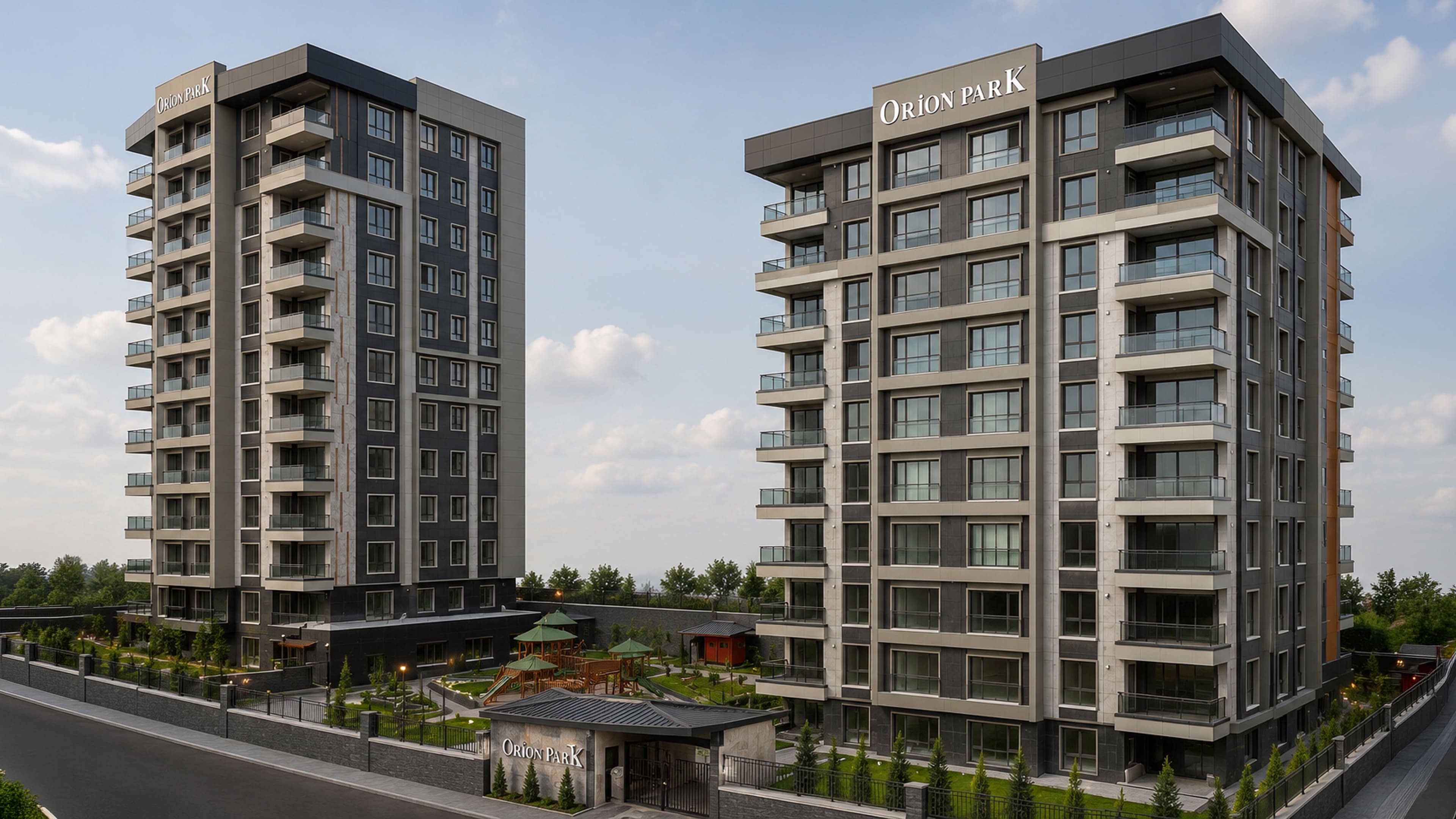 Orion Park'ın çatılarında adı yazan iki konut bloğunun havadan görünümü; önlerinden geçen yol, düzenlenmiş yeşil peyzaj ve arkada şehir silueti