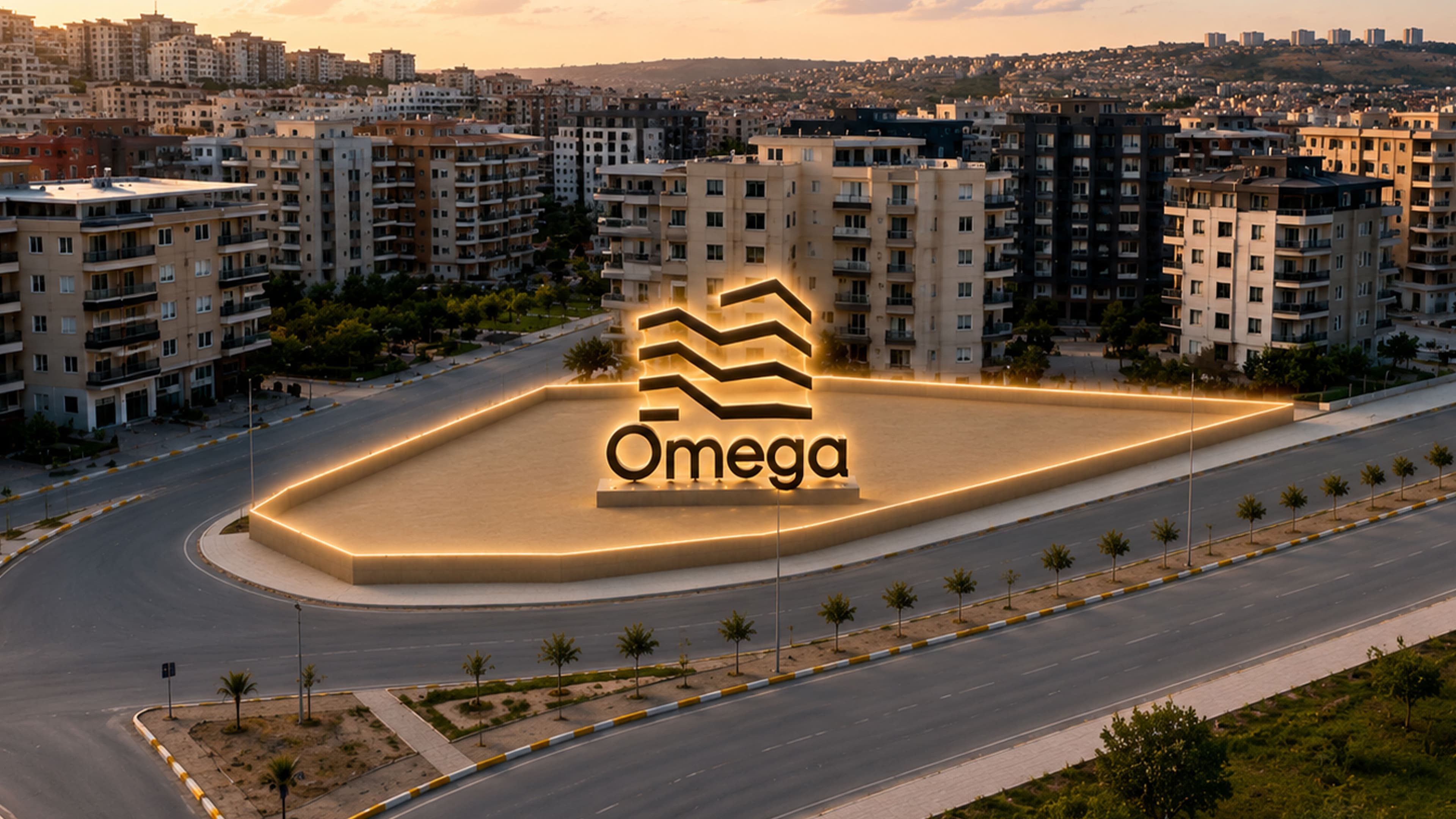 Altın saat ışığında Omega anıt tabelası; ardında Buluntu Hoca Bulvarı boyunca uzanan konut blokları ve ufka açılan şehir silueti